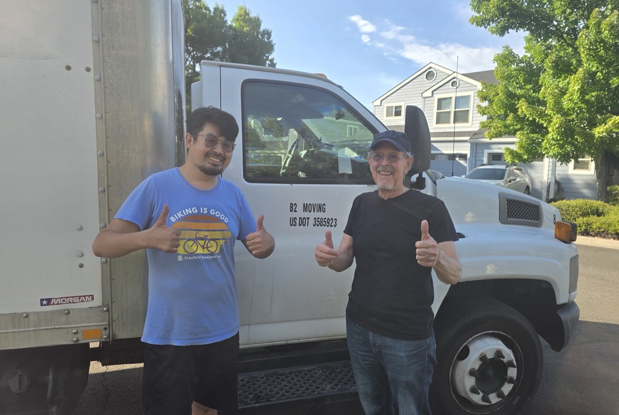Two happy customers with the B2 Moving truck